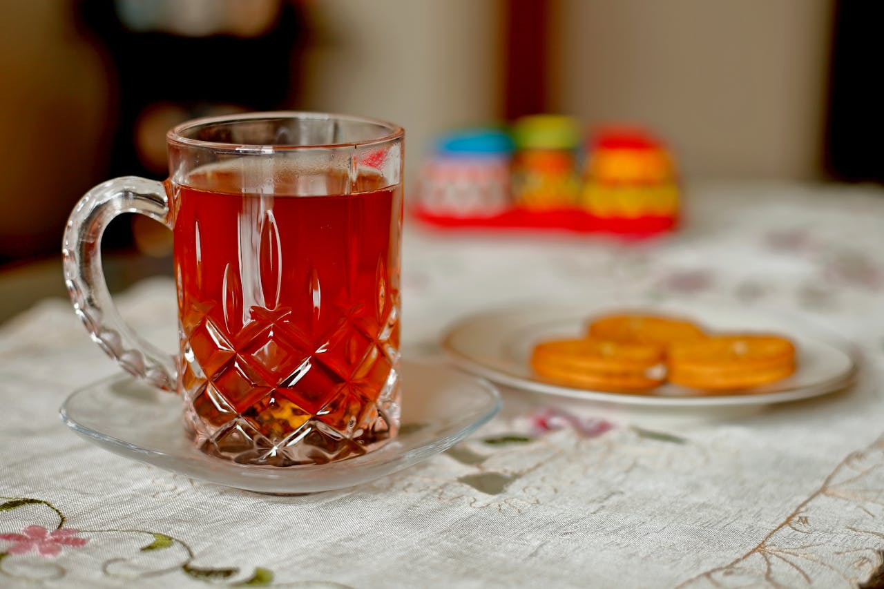 Close-up of a tea cup and biscuits on a table in an indoor setting in Dhaka.